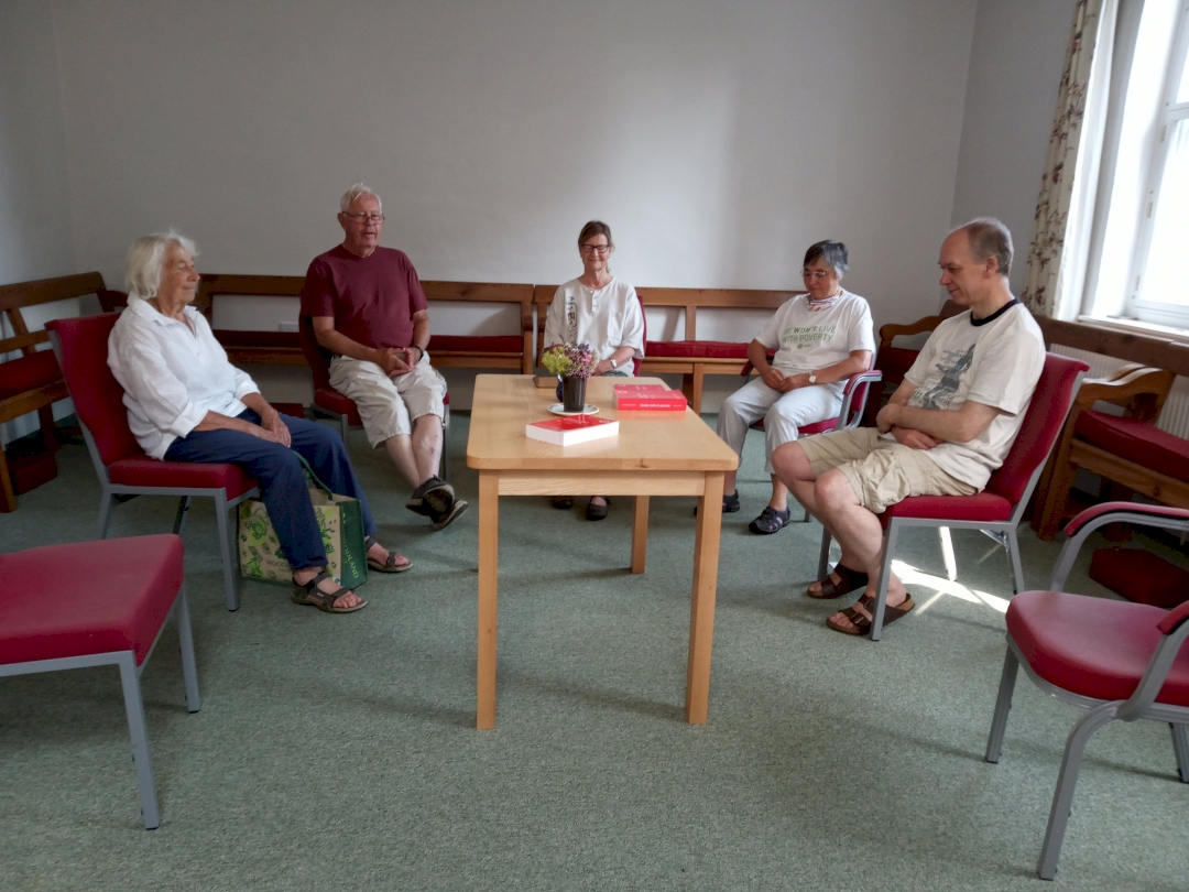 Photograph of five people in Meeting for Worship in the Meeting Room